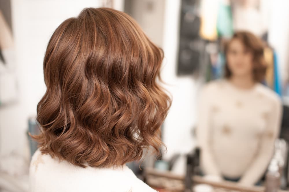 Medium length wavy hair styled after cut and blow dry