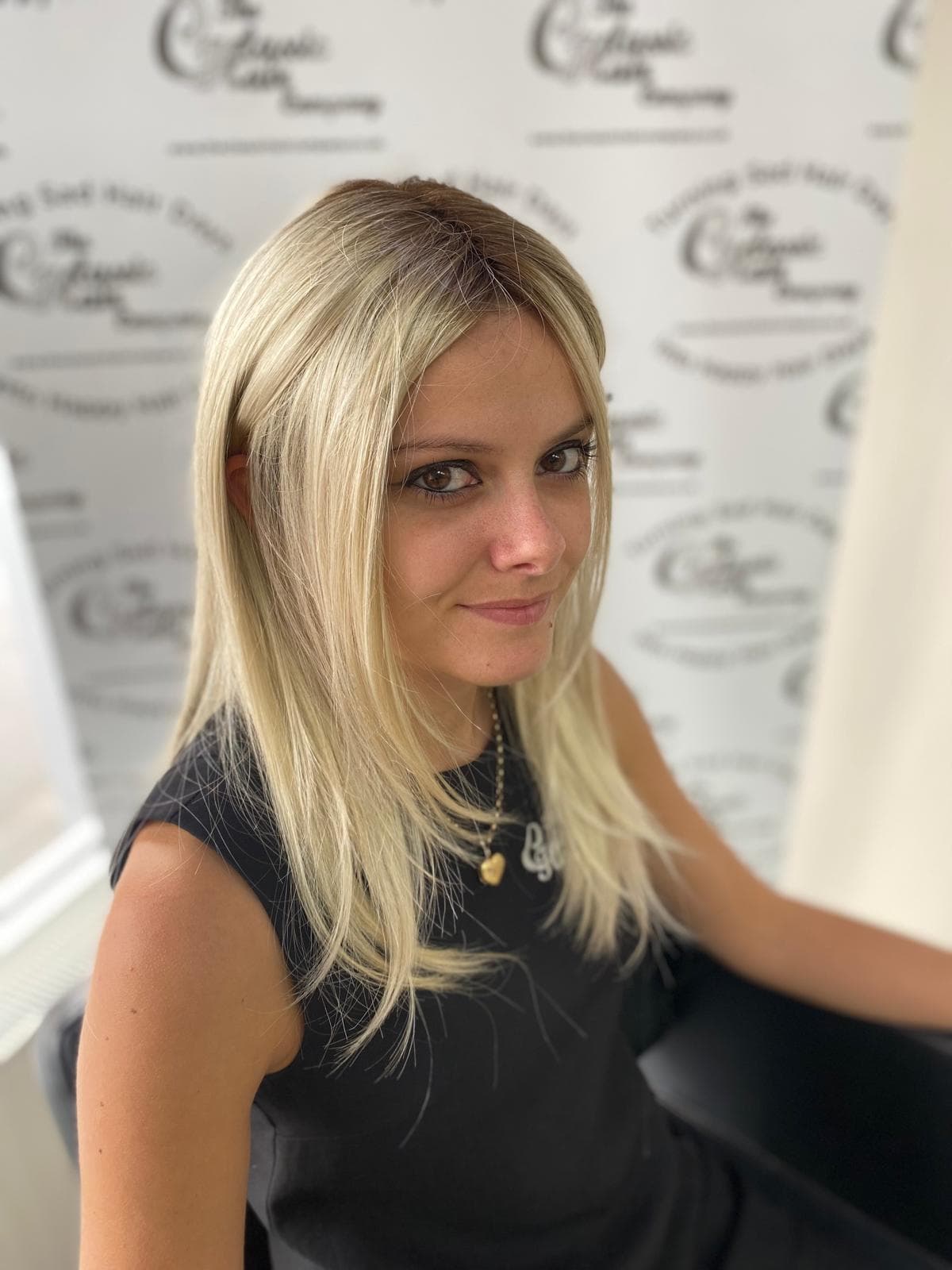 Smiling woman with long straight hair, Danielle Smith Advanced Stylist at The Classic Hair Company in Tilbury, Essex.