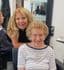 Debbie Wiseman, Style Director and salon owner at The Classic Hair Company in Tilbury, Essex, smiling with a client in the salon.