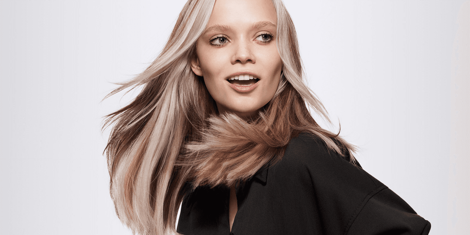 Woman with multi tonal blonde hair coloured using Goldwell Colorance demi colour