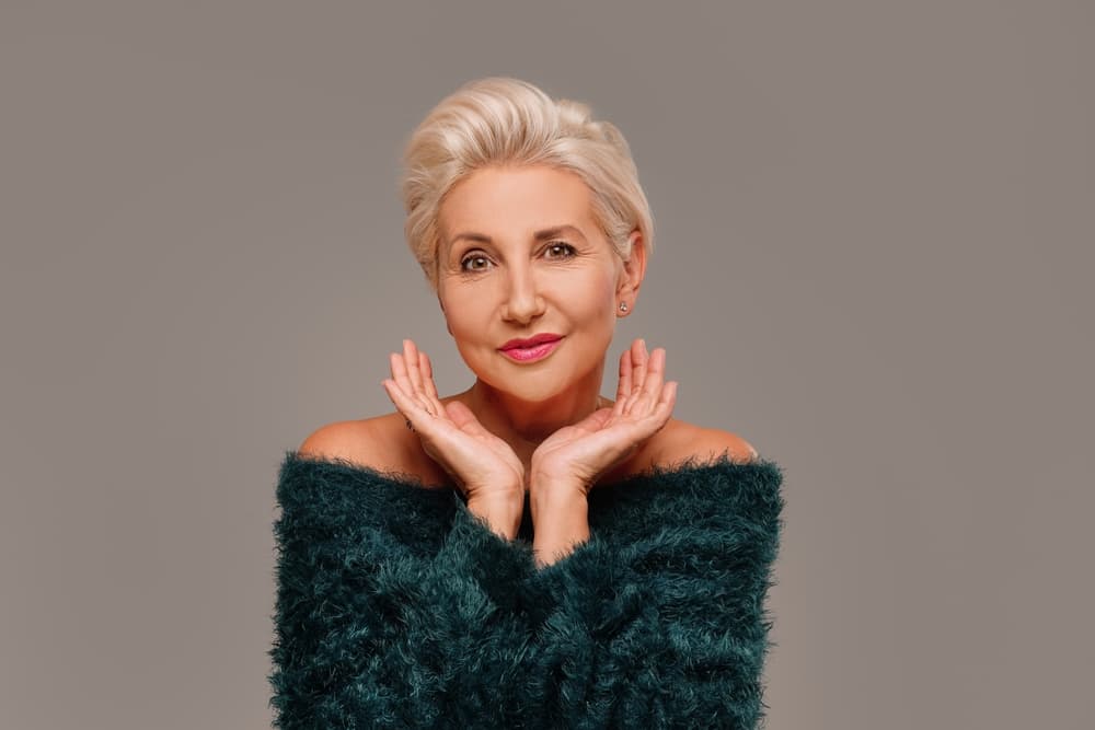 Mature woman with short blonde hair styled with full head highlights