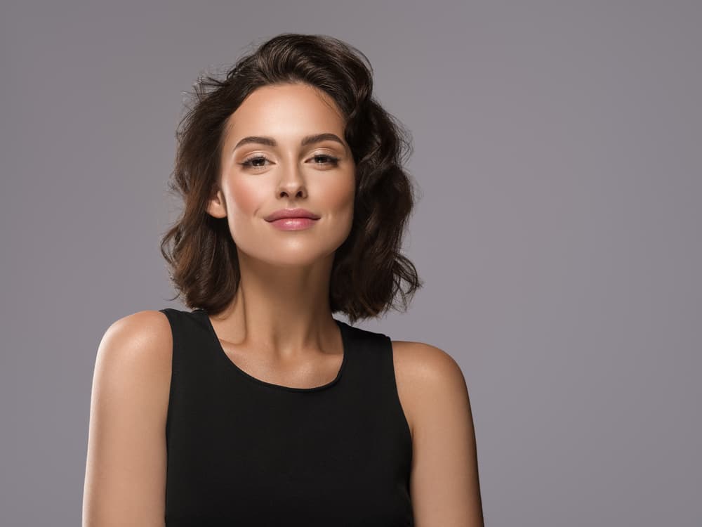 Woman with medium length dark hair coloured using full head tint