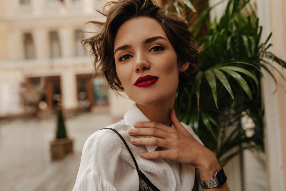 Woman with short styled hair coloured using full head tint
