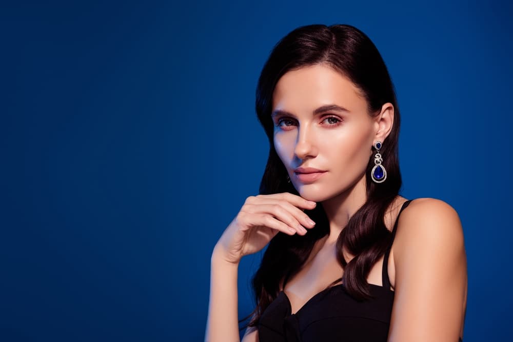 Woman with glossy dark hair styled after professional root tint
